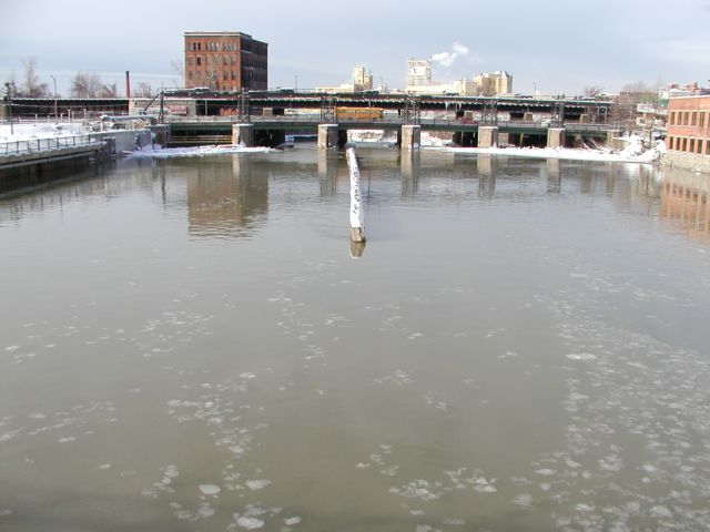 Picture Ice flows north on the Genesee River as it heads for a drop over the High Falls portion of the river. Rochester NY New York City living January 14th 2003 POD I Love NY Rochester NY New York Picture Of The Day view picture photo image pictures photos images, January 14th 2003 POD