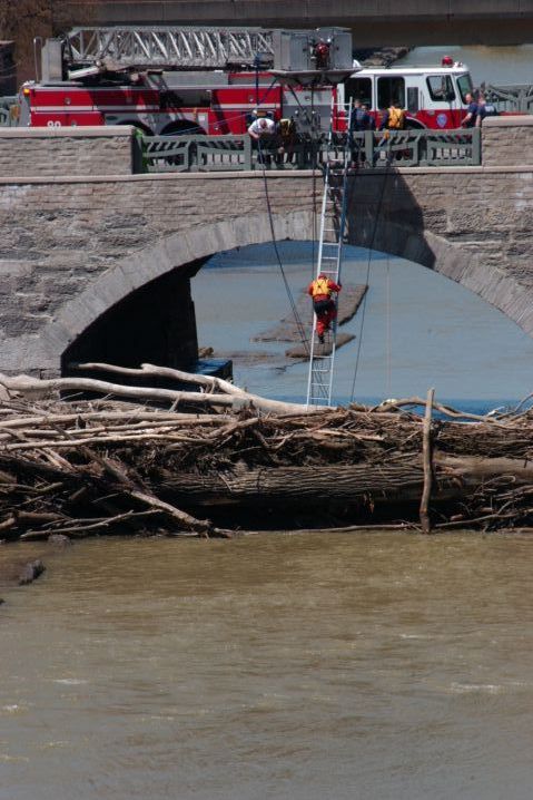 Picture - A Rochester NY Firefighter Uses A Ladder To Enter The Genesee River While Rescuing A Man That Jumped From The Main St. Bridge. 24 Hour Fresh 1:52 PM. May 9th 2005 POD. - Rochester NY Picture Of The Day from RocPic.Com spring summer fall winter pictures photos images people buildings events concerts festivals photo image at new images daily Rochester New York Fall I Love NY I luv NY Rochester New York 2004 POD view picture photo image pictures photos images